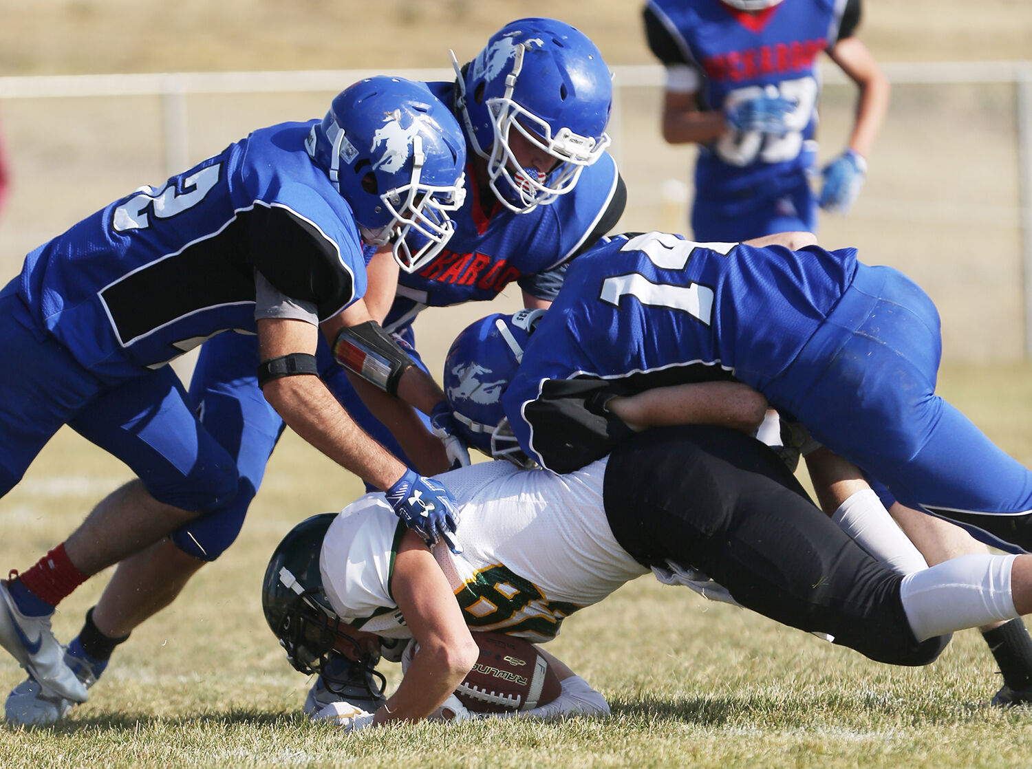Kaycee defenders move in together for a tackle